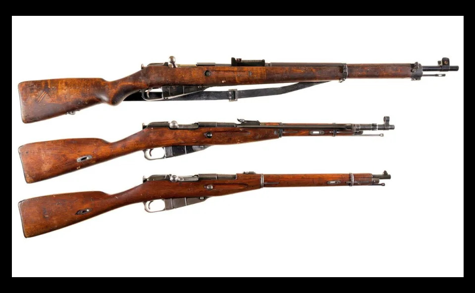 A full-sized Finish M39 variant of the Mosin-Nagant (top) above two Russian carbine-length Mosins.